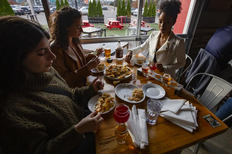 Table filled with food and people eating it
