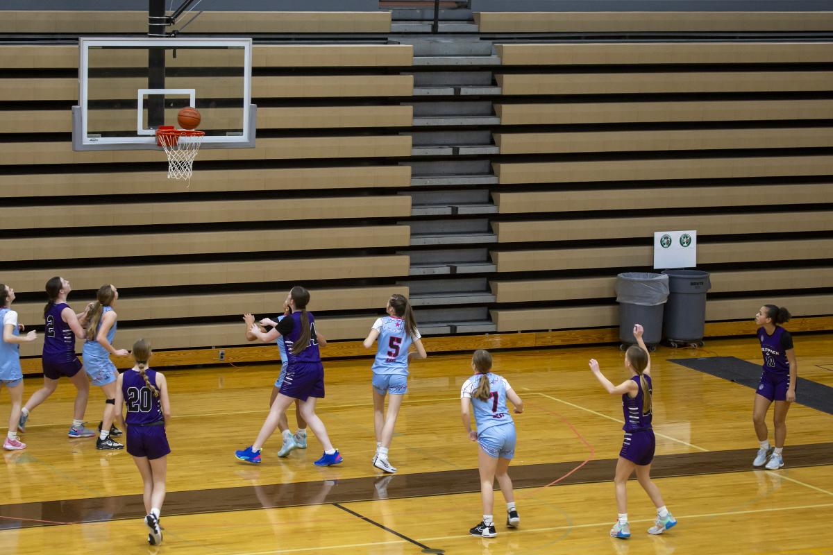 Girls basketball team competing against each other